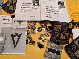 Forty-five pieces of military insignia and badges
