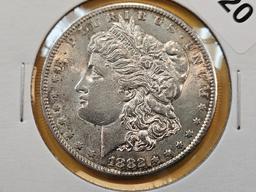 Two About Uncirculated Morgan Silver Dollars