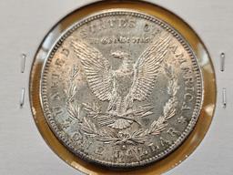 Two About Uncirculated Morgan Silver Dollars
