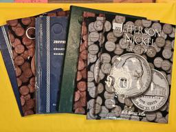 Seven mixed, full and partially full coin albums