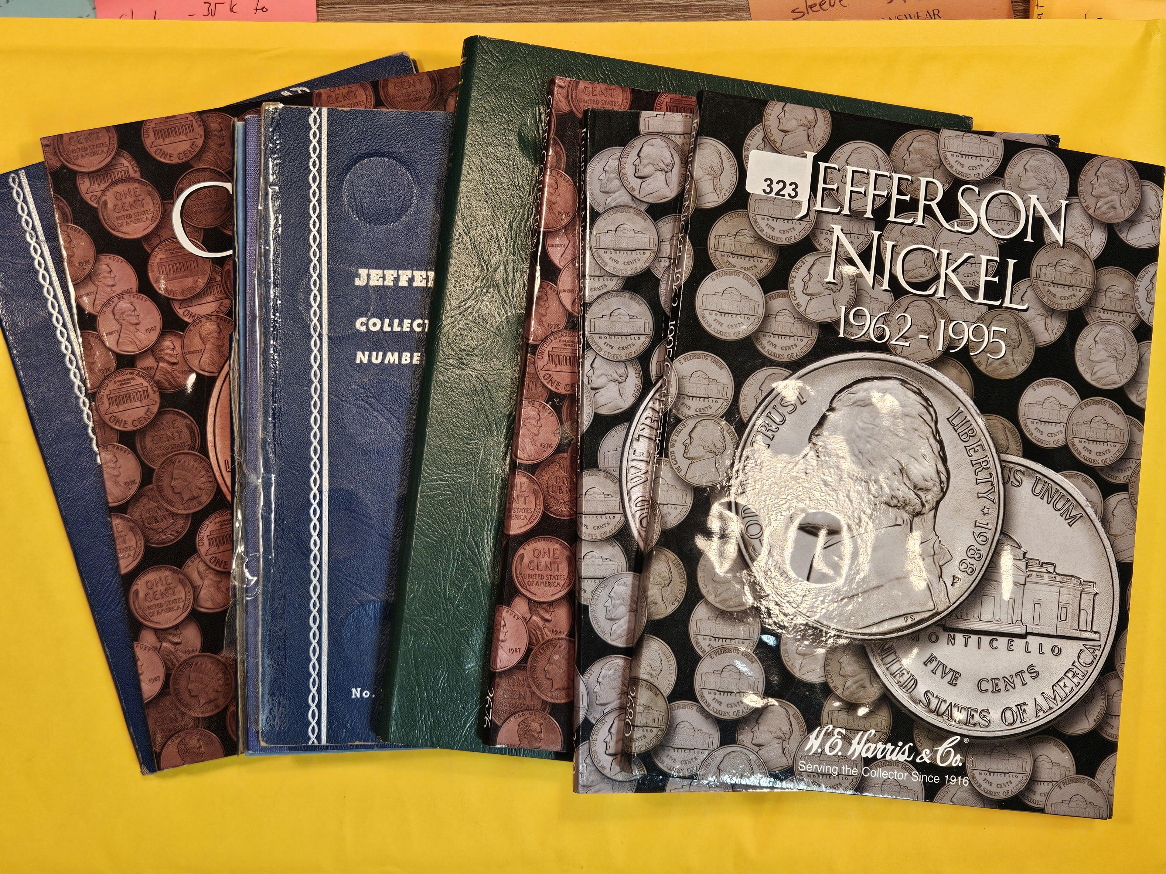 Seven mixed, full and partially full coin albums