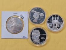 Three GEM Proof and one Business Strike Commemorative Silver Dollars