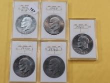 One GEM Proof and Four Uncirculated Eisenhower Dollars, One Silver