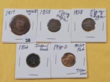 Five US One Cent coins, four different designs