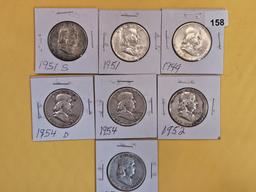 Seven mixed silver Franklin Half Dollars