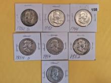Seven mixed silver Franklin Half Dollars