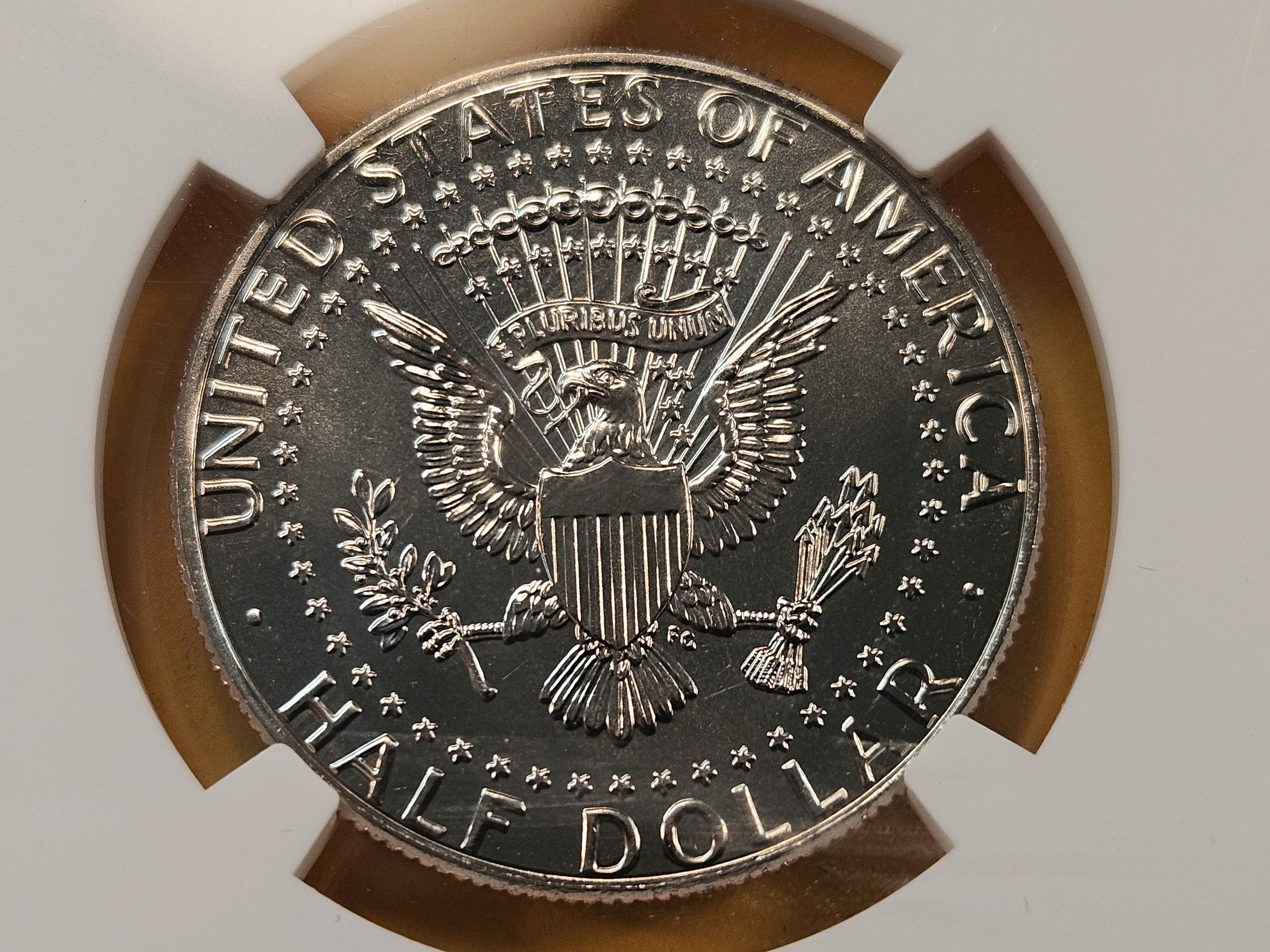 Two NGC Graded Kennedy Clad Half Dollars