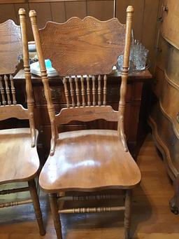 Six pressed back chairs