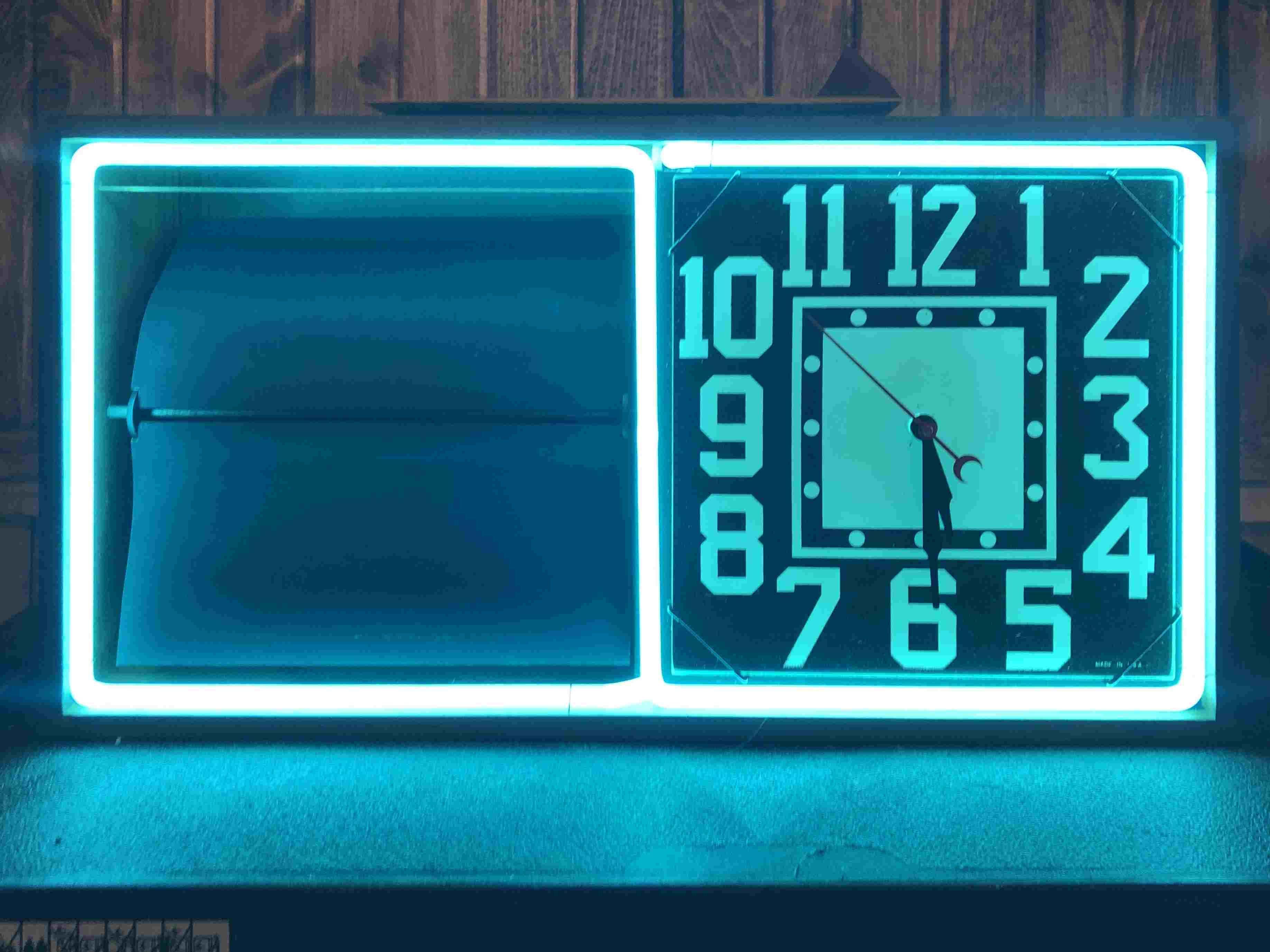 Neon clock with rotating panels
