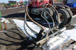 Skid mount bale squeezer