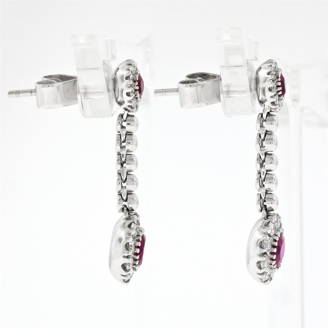 Fancy 18K White Gold 1.38 ctw Round Ruby w/ Diamond Halo Post Drop Dangle Earrin