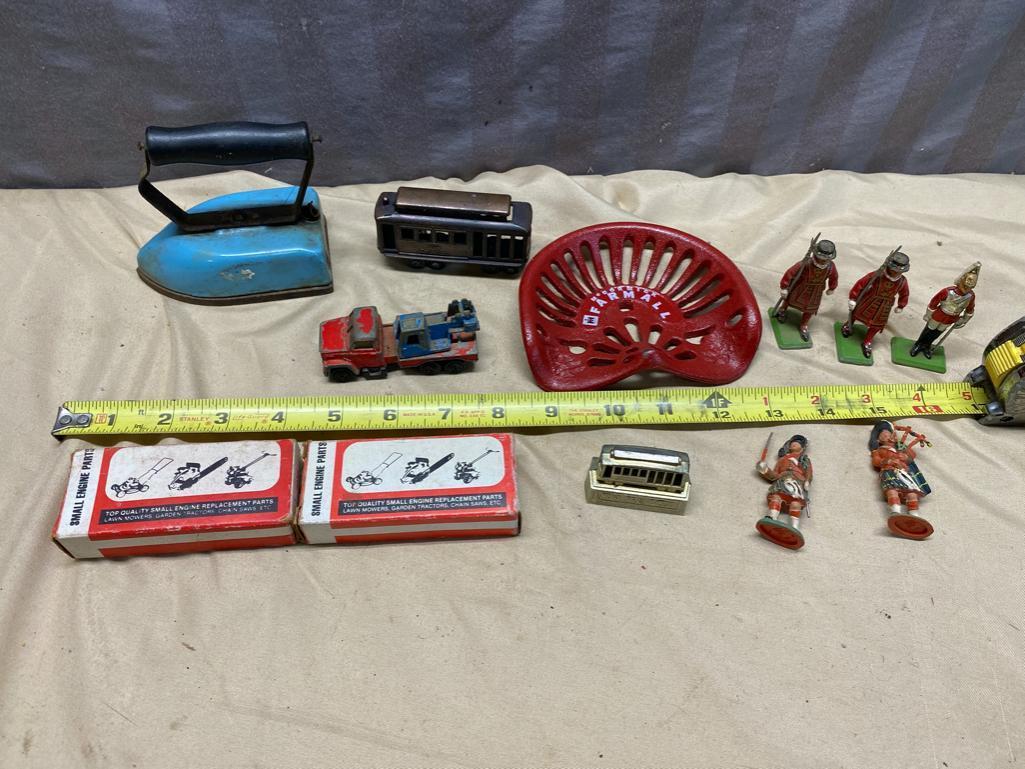 Assorted Toy Soldiers, Small Toy Tractor seat, Vintage Child's Iron, and 2 small engine parts kits