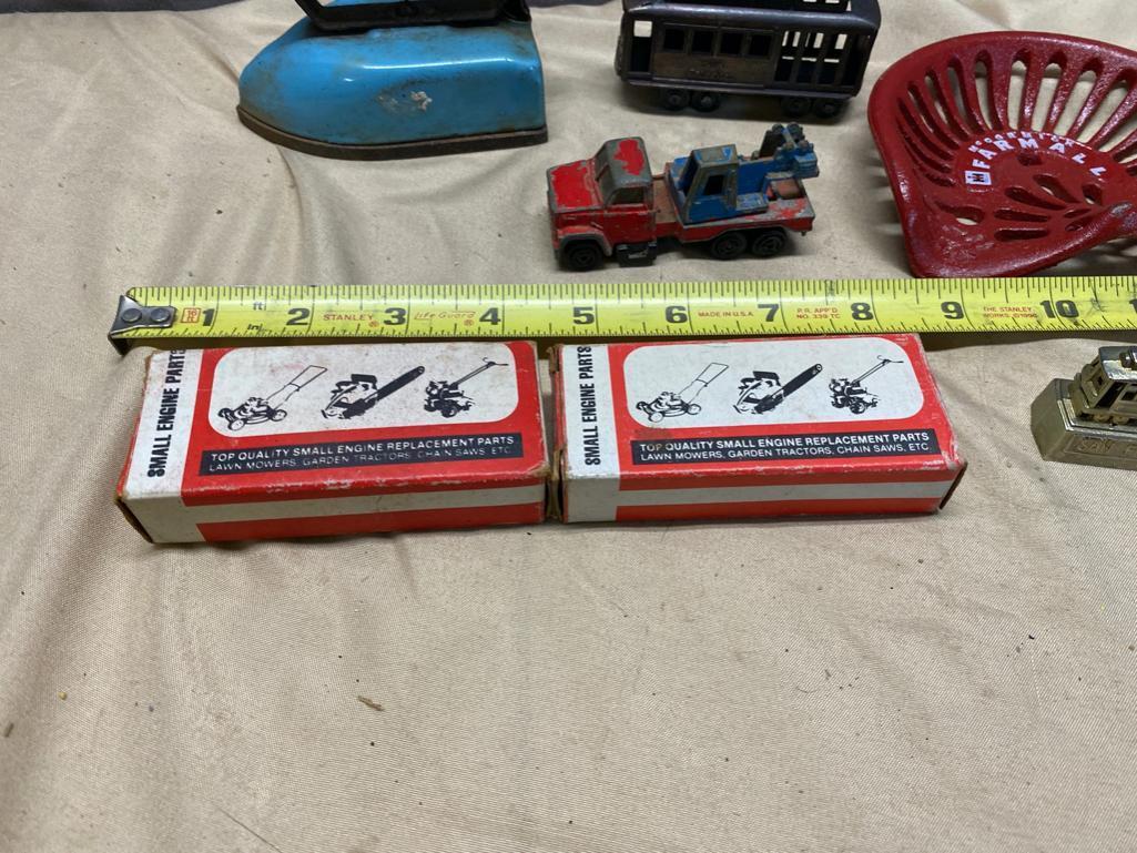 Assorted Toy Soldiers, Small Toy Tractor seat, Vintage Child's Iron, and 2 small engine parts kits