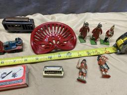 Assorted Toy Soldiers, Small Toy Tractor seat, Vintage Child's Iron, and 2 small engine parts kits