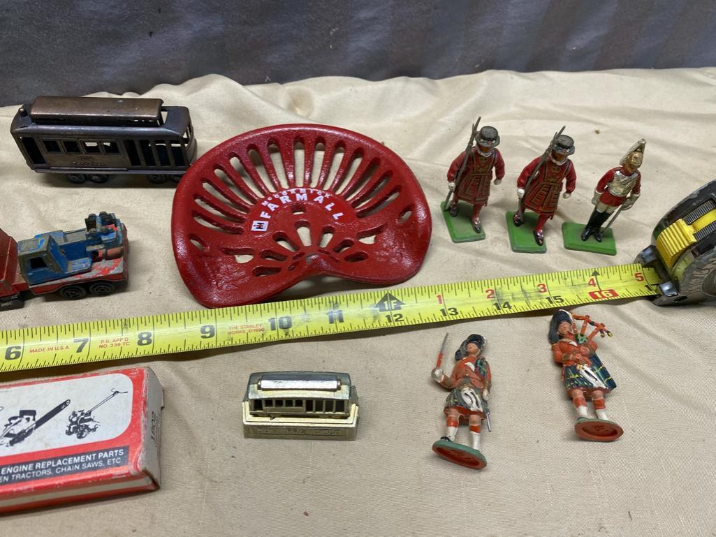 Assorted Toy Soldiers, Small Toy Tractor seat, Vintage Child's Iron, and 2 small engine parts kits