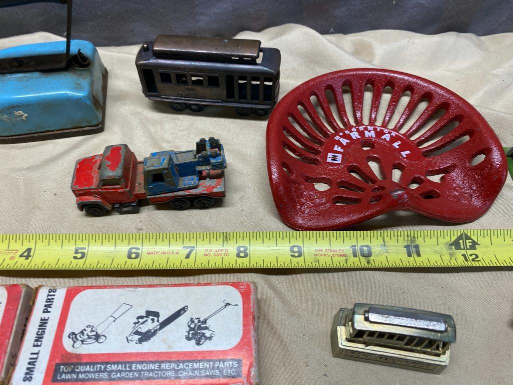 Assorted Toy Soldiers, Small Toy Tractor seat, Vintage Child's Iron, and 2 small engine parts kits