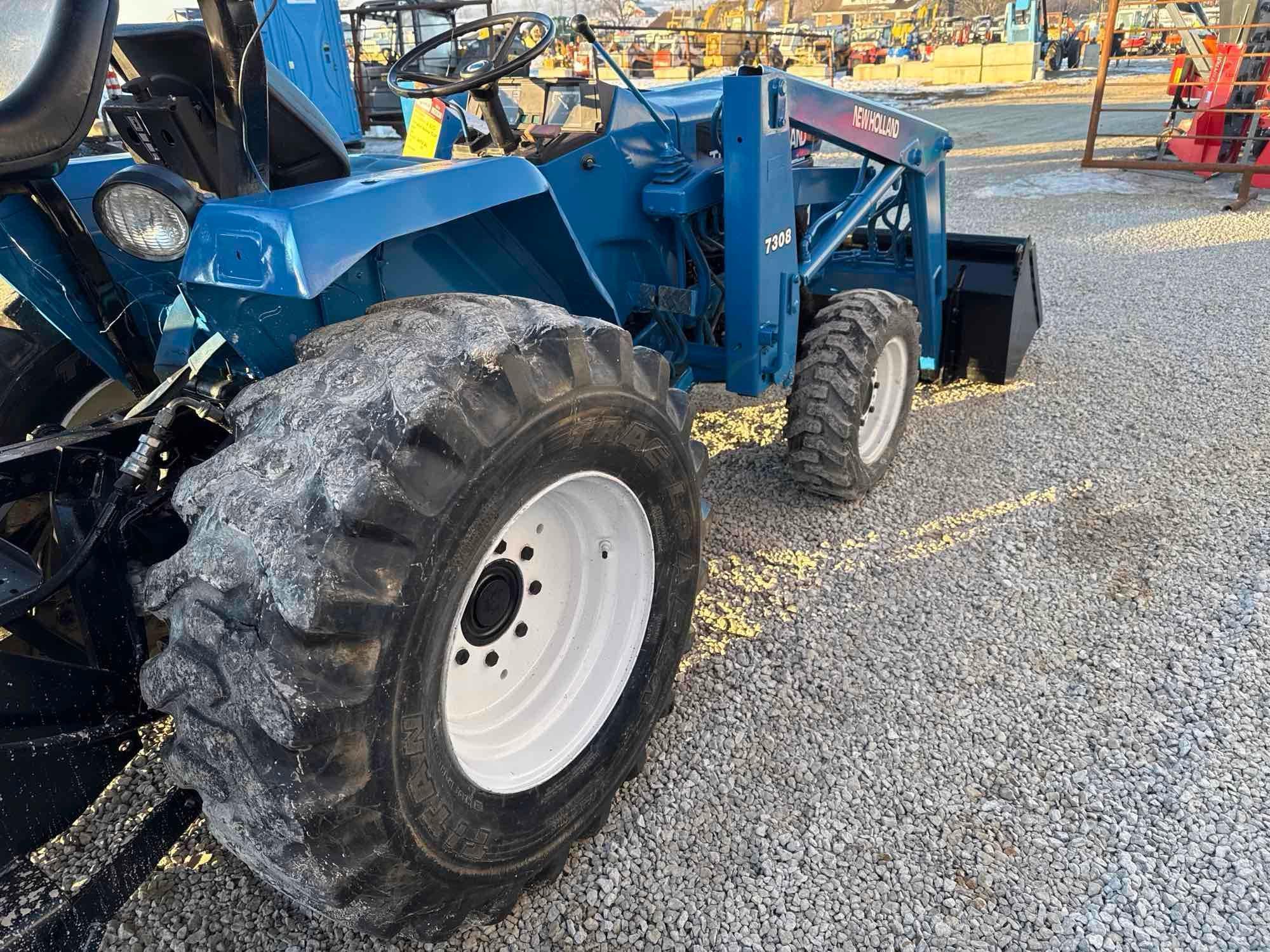 New Holland TC30 Tractor, bucket & backhoe 2278 hrs., SN 324596 on bucket