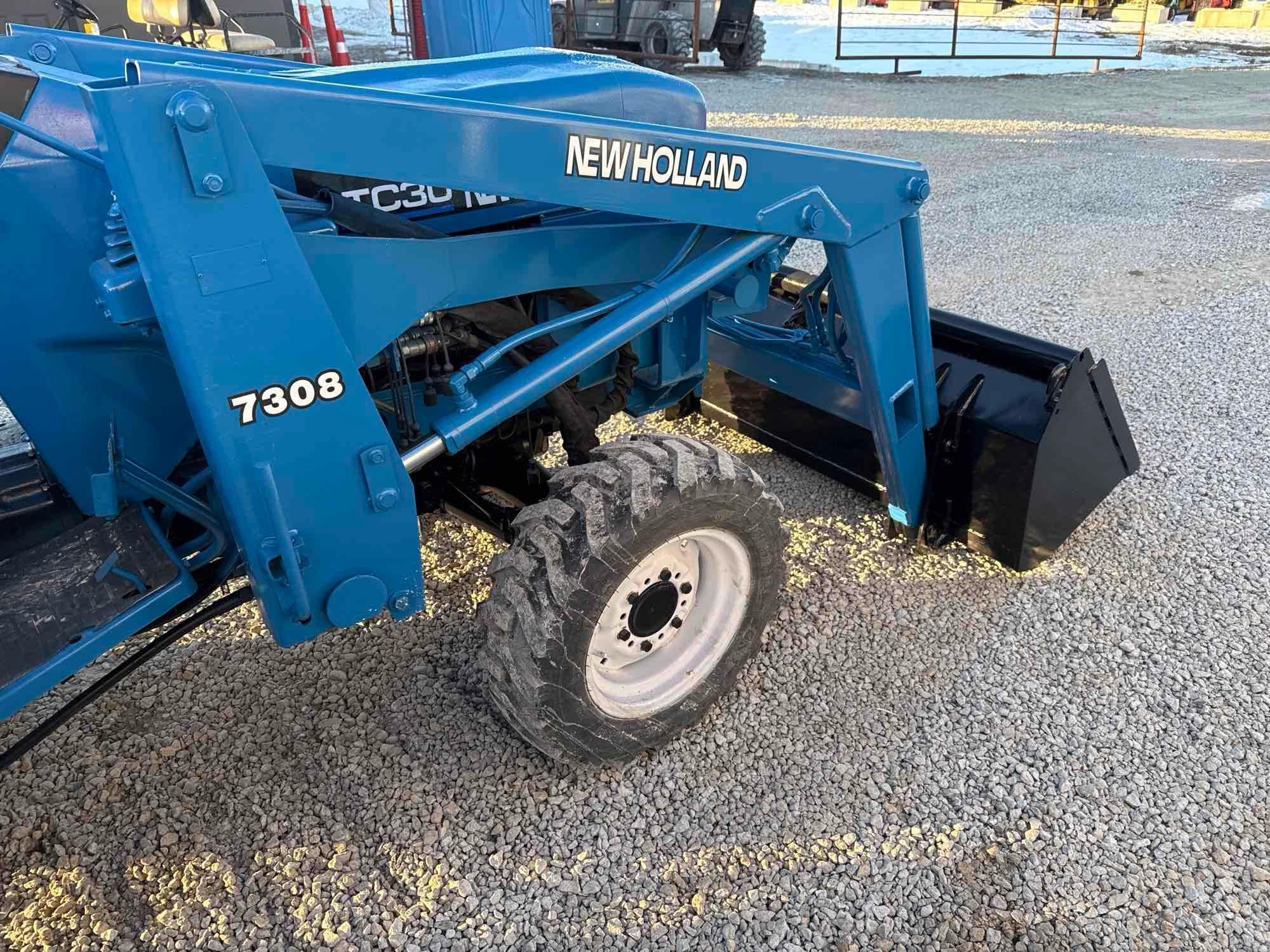 New Holland TC30 Tractor, bucket & backhoe 2278 hrs., SN 324596 on bucket