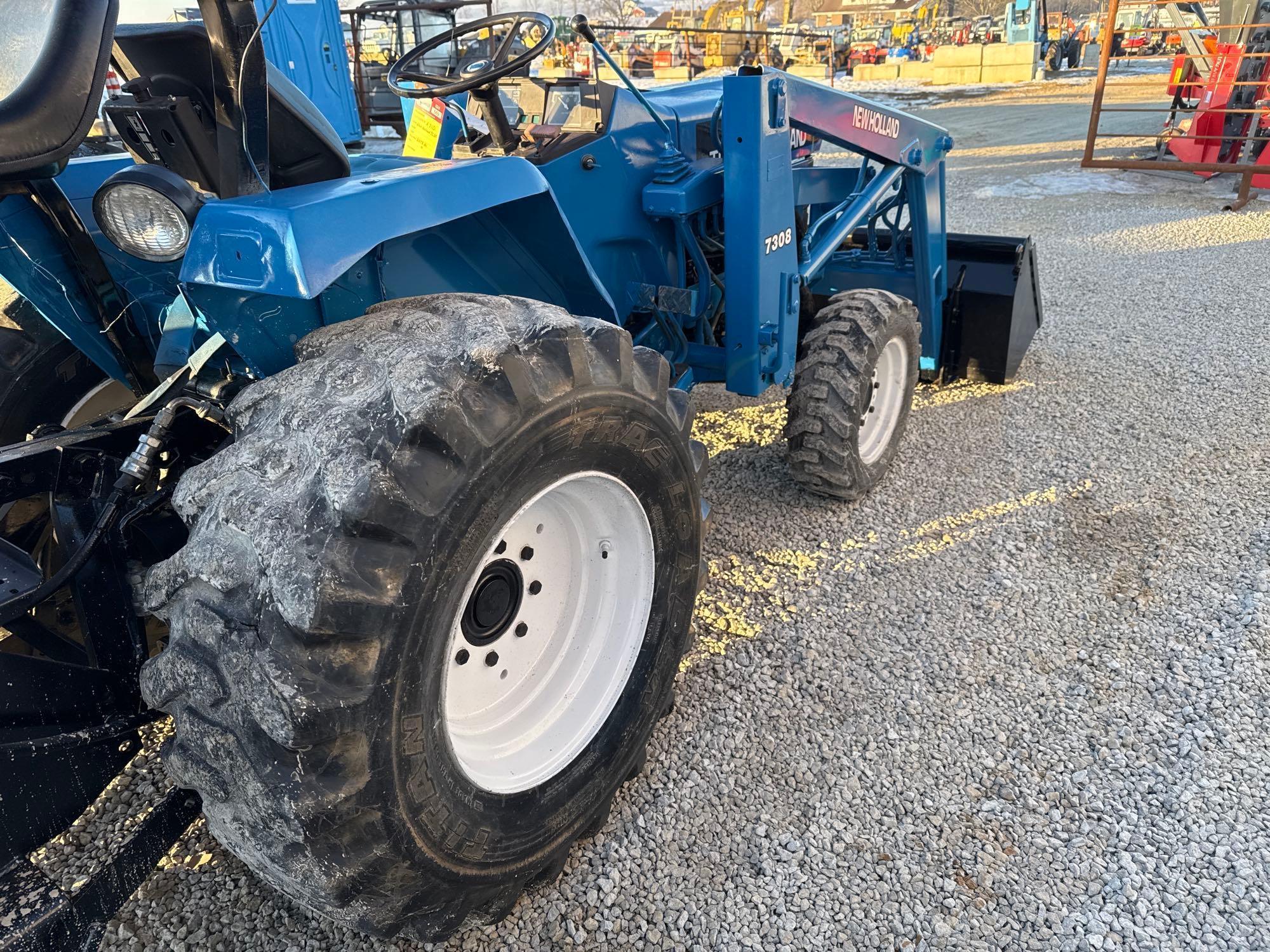 New Holland TC30 Tractor, bucket & backhoe 2278 hrs., SN 324596 on bucket