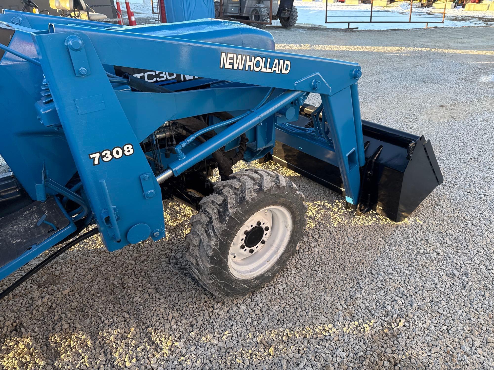 New Holland TC30 Tractor, bucket & backhoe 2278 hrs., SN 324596 on bucket