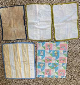 Five small quilted doll blankets