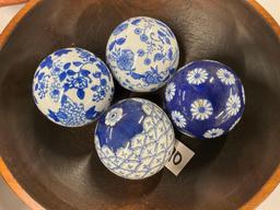 Pair of wooden bowls with blue and white pattern glass balls and pottery sun face