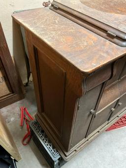 Singer Treadle sewing machine in oak cabinet