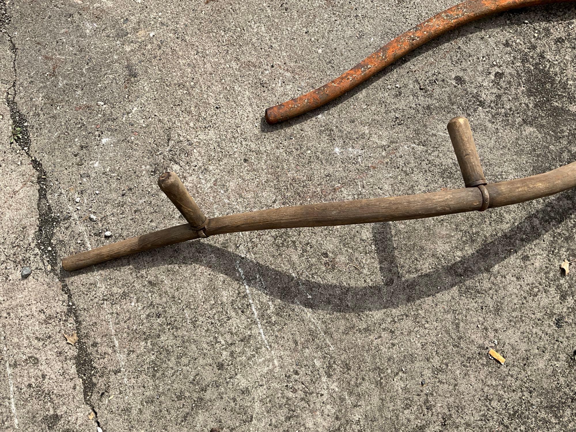 Wood handled scythe and iron pump handle