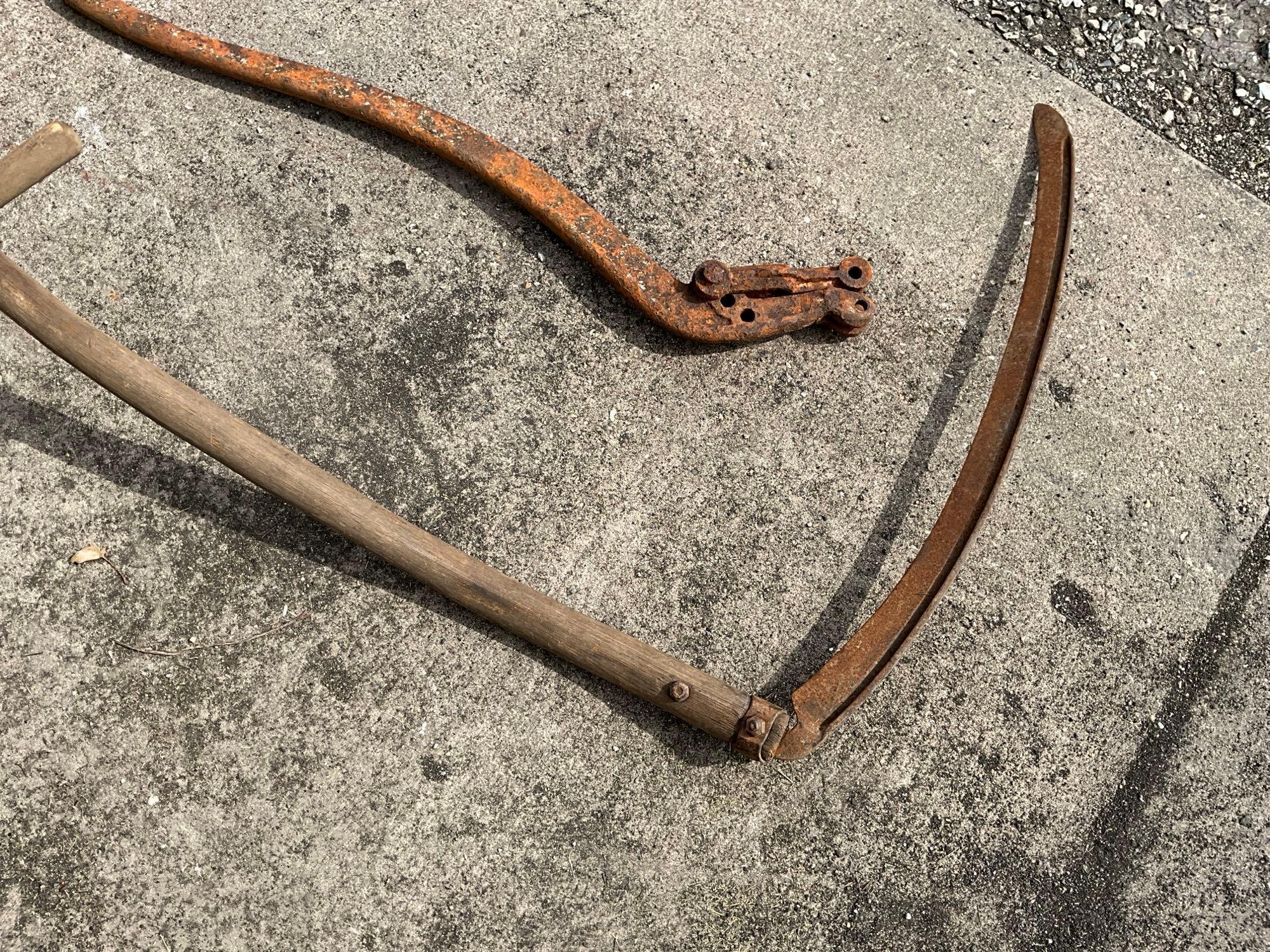 Wood handled scythe and iron pump handle