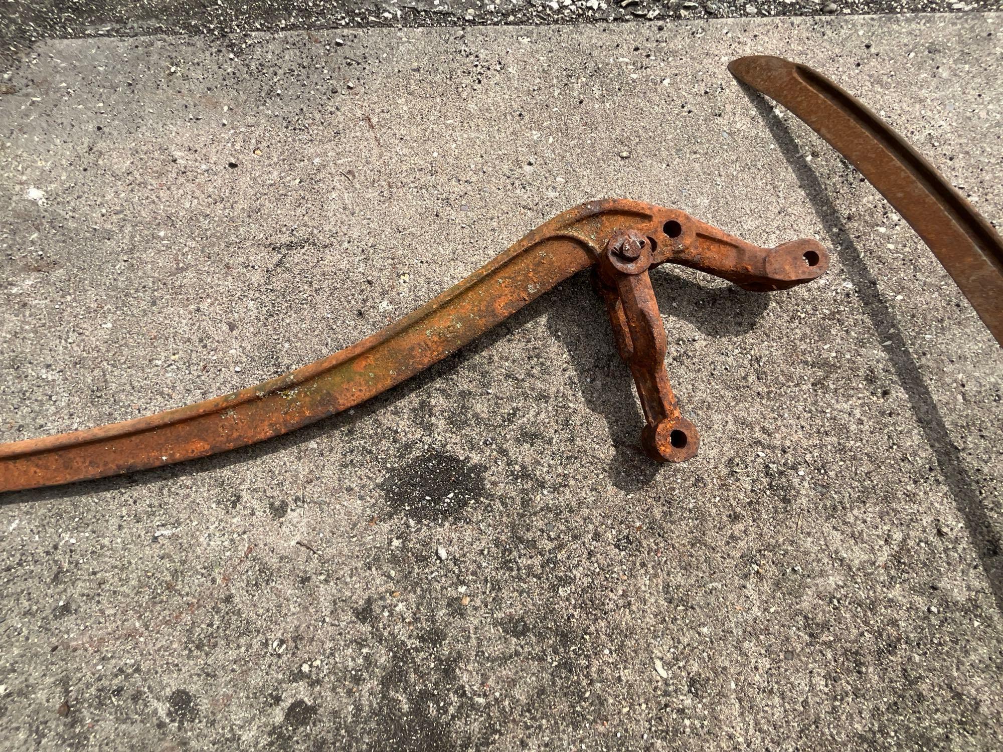 Wood handled scythe and iron pump handle
