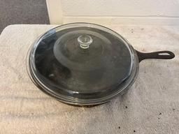 unmarked #10 cast iron skillet w/glass lid & unmarked #14 cast iron skillet