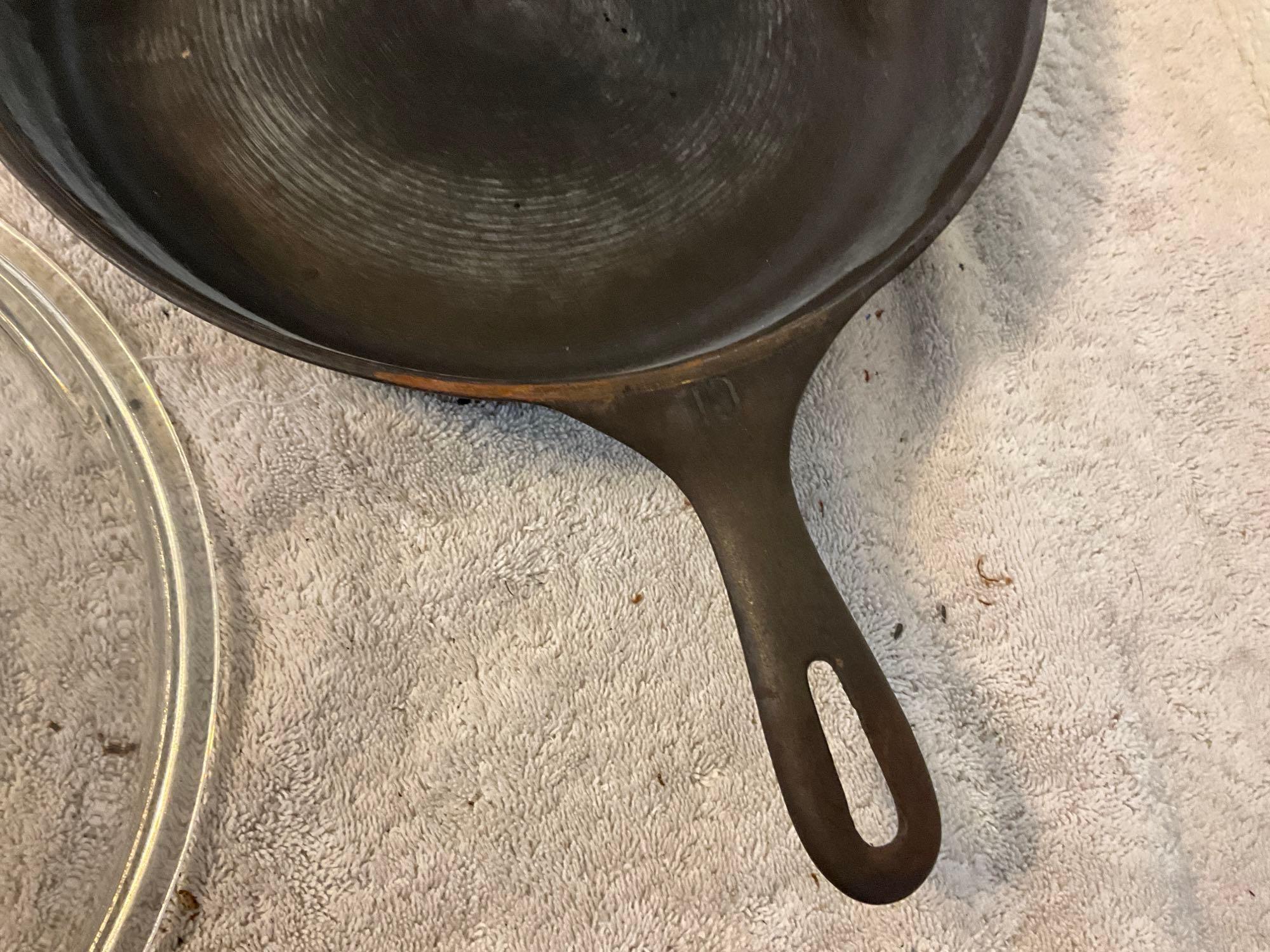 unmarked #10 cast iron skillet w/glass lid & unmarked #14 cast iron skillet