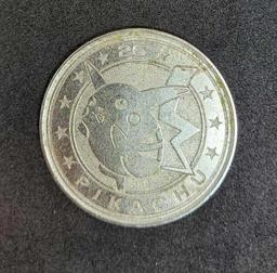 Gold plated Charizard pokemon card and Pikachu coin