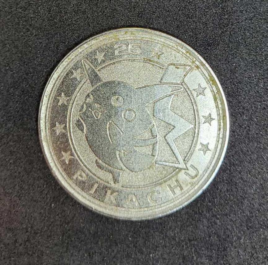 Gold plated Charizard pokemon card and Pikachu coin