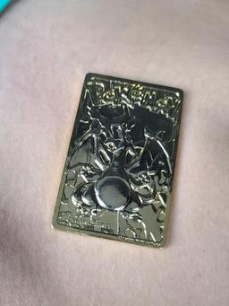 Gold plated Charizard pokemon card and Pikachu coin