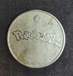 Gold plated Charizard pokemon card and Pikachu coin