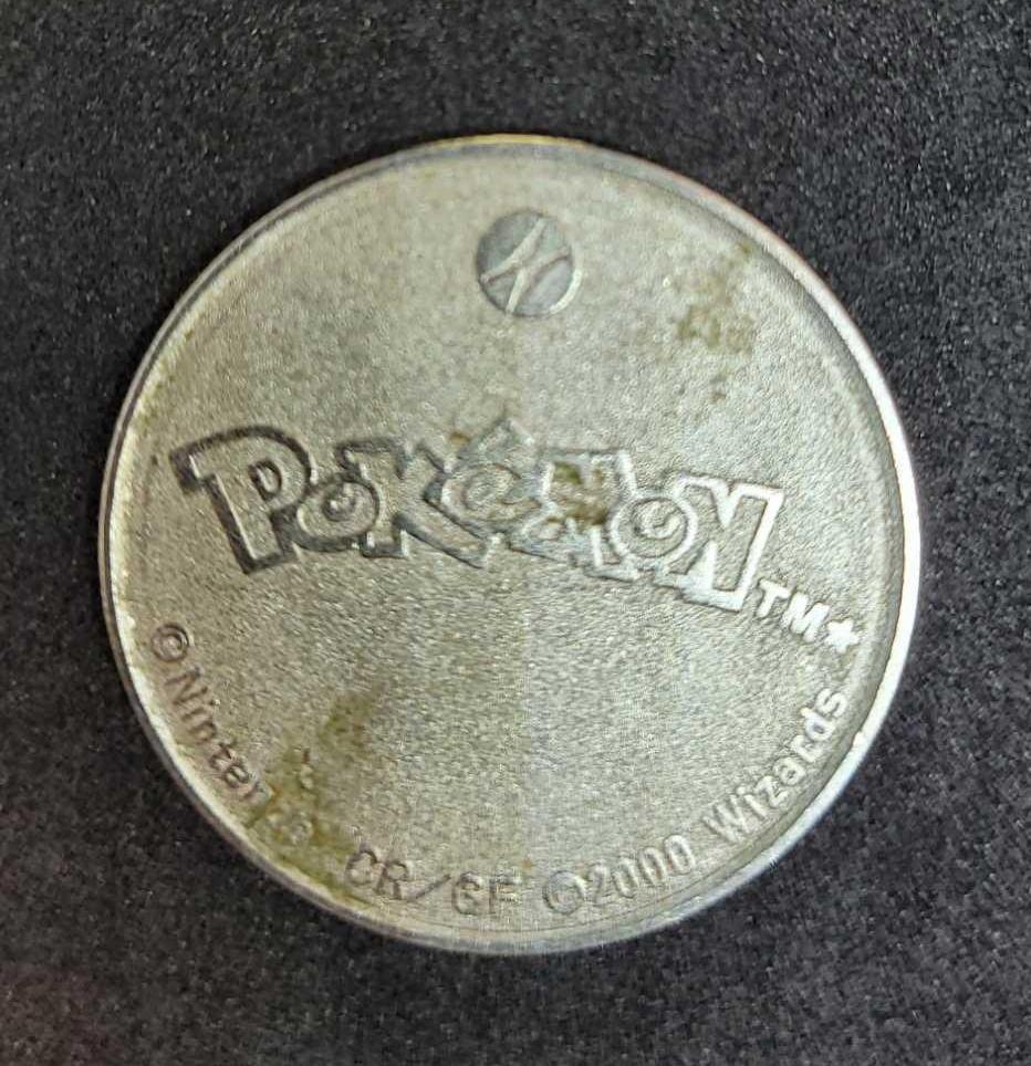 Gold plated Charizard pokemon card and Pikachu coin