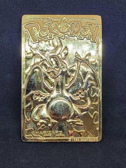 Gold plated Charizard pokemon card and Pikachu coin