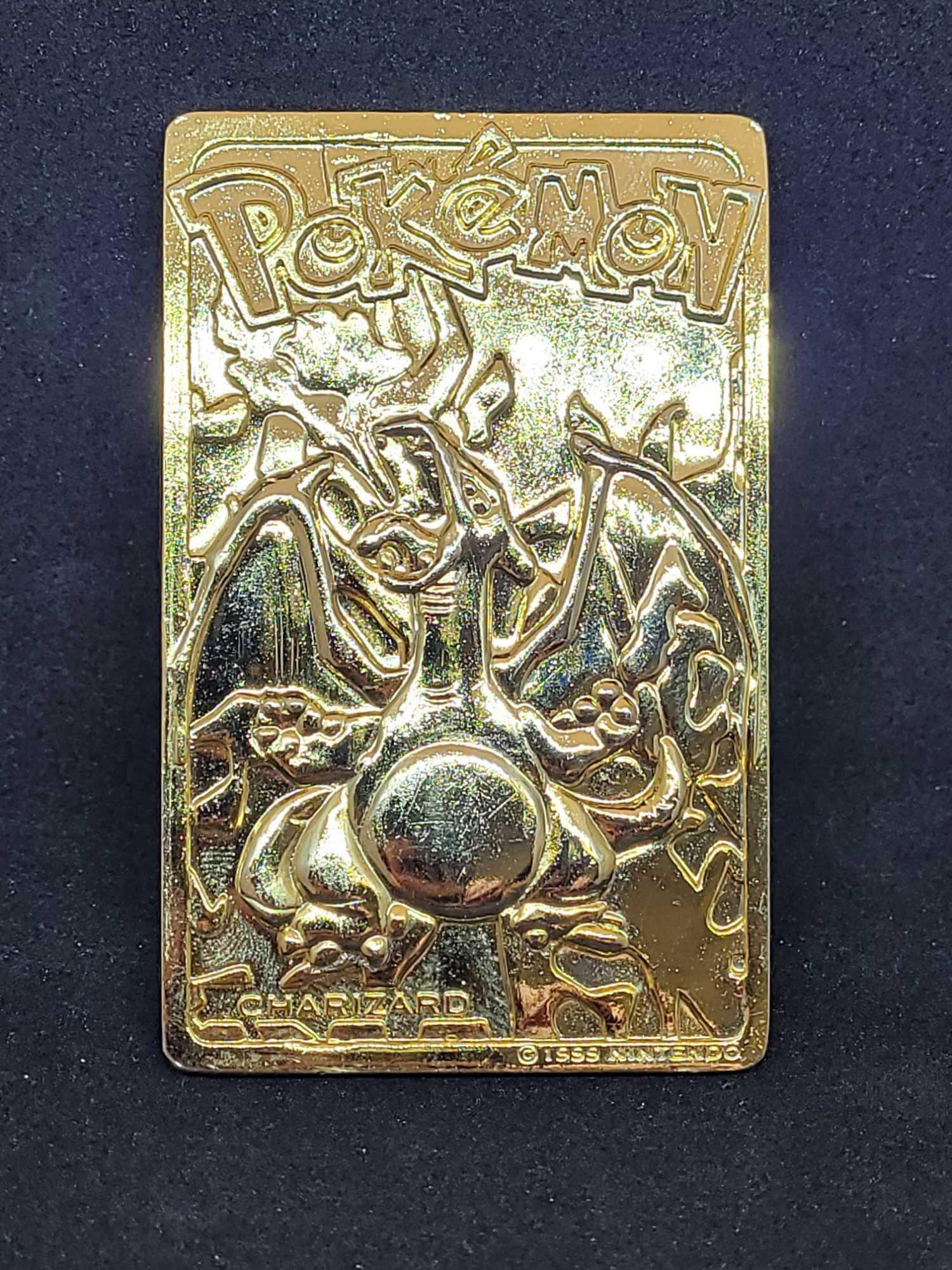 Gold plated Charizard pokemon card and Pikachu coin