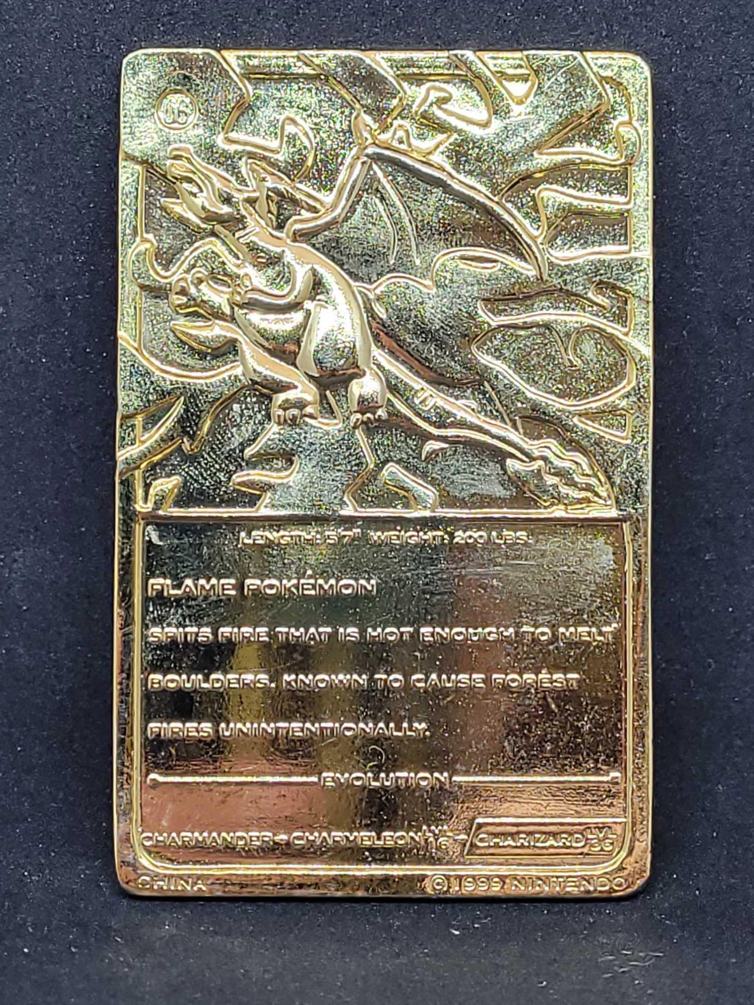 Gold plated Charizard pokemon card and Pikachu coin