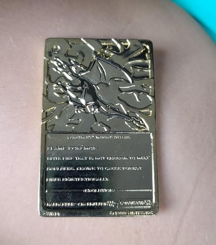 Gold plated Charizard pokemon card and Pikachu coin