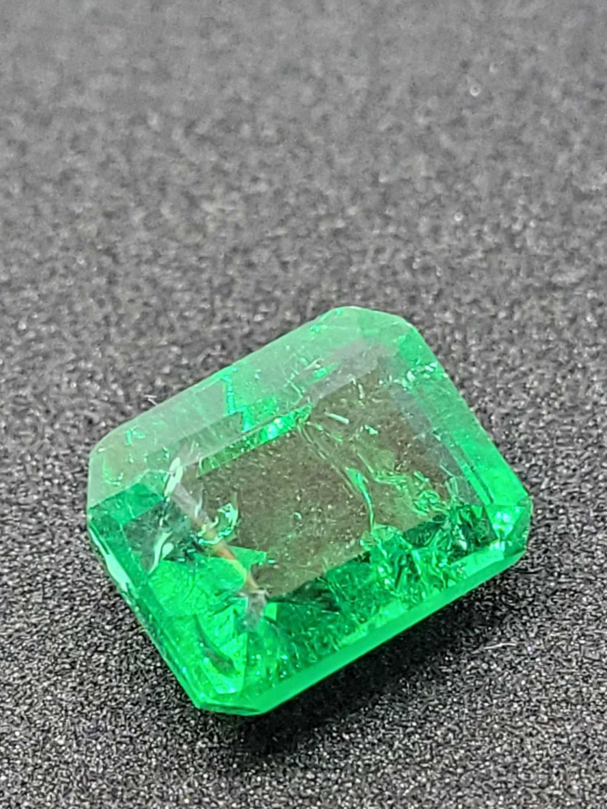 Green Emerald gemstone 9.57ct Emerald cut with gym ID card