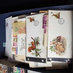 box of stamps and stamped envelopes from around the world