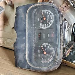 Large box of misc Harley Davidson parts speedometer brackets covers etc.