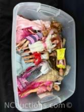 bin of Barbie dolls and cloths