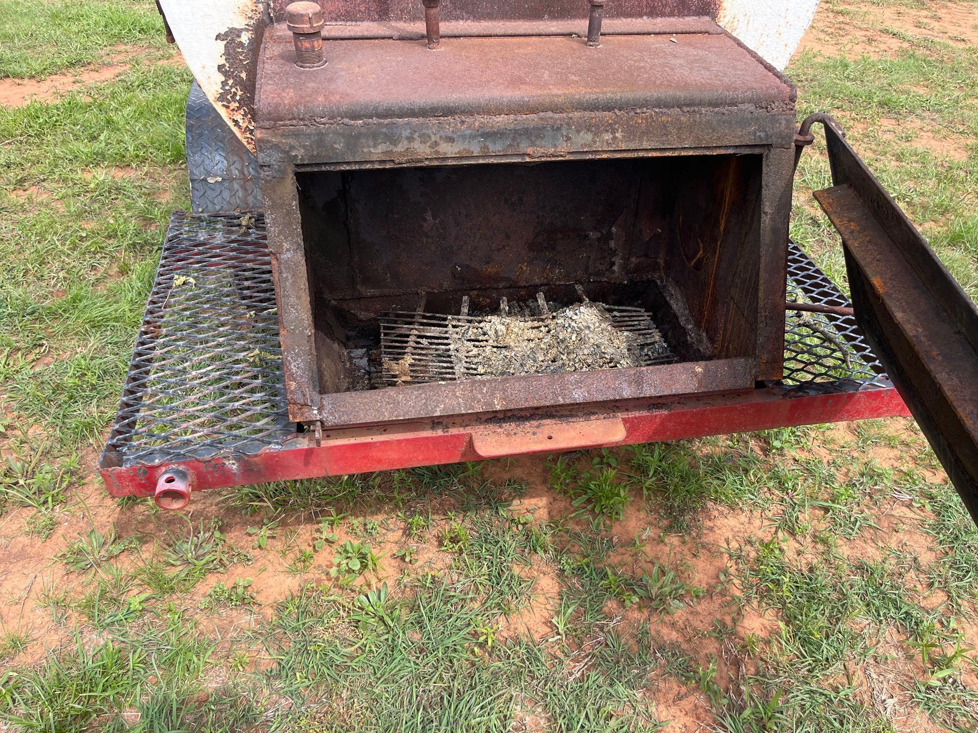 large wood smoker on a trailer