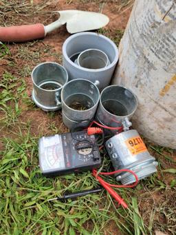 bucket of concrete working tools, straps 2in conduit couplings, garden shovel