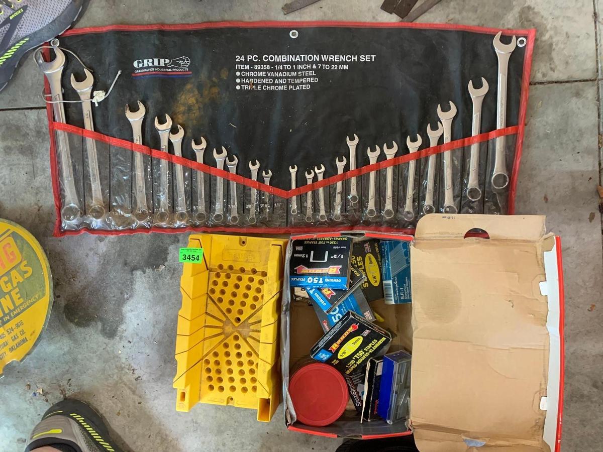 22. Standard and metric opening wrenches in pouch, staple assortment, and miter box.