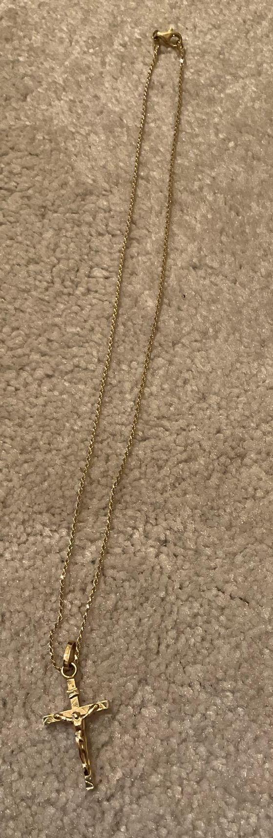 Golden necklace with golden cross with Jesus on it