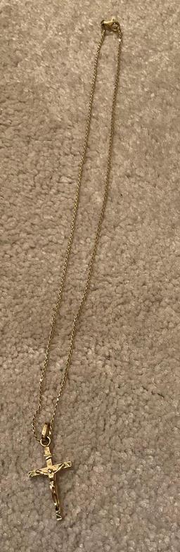 Golden necklace with golden cross with Jesus on it